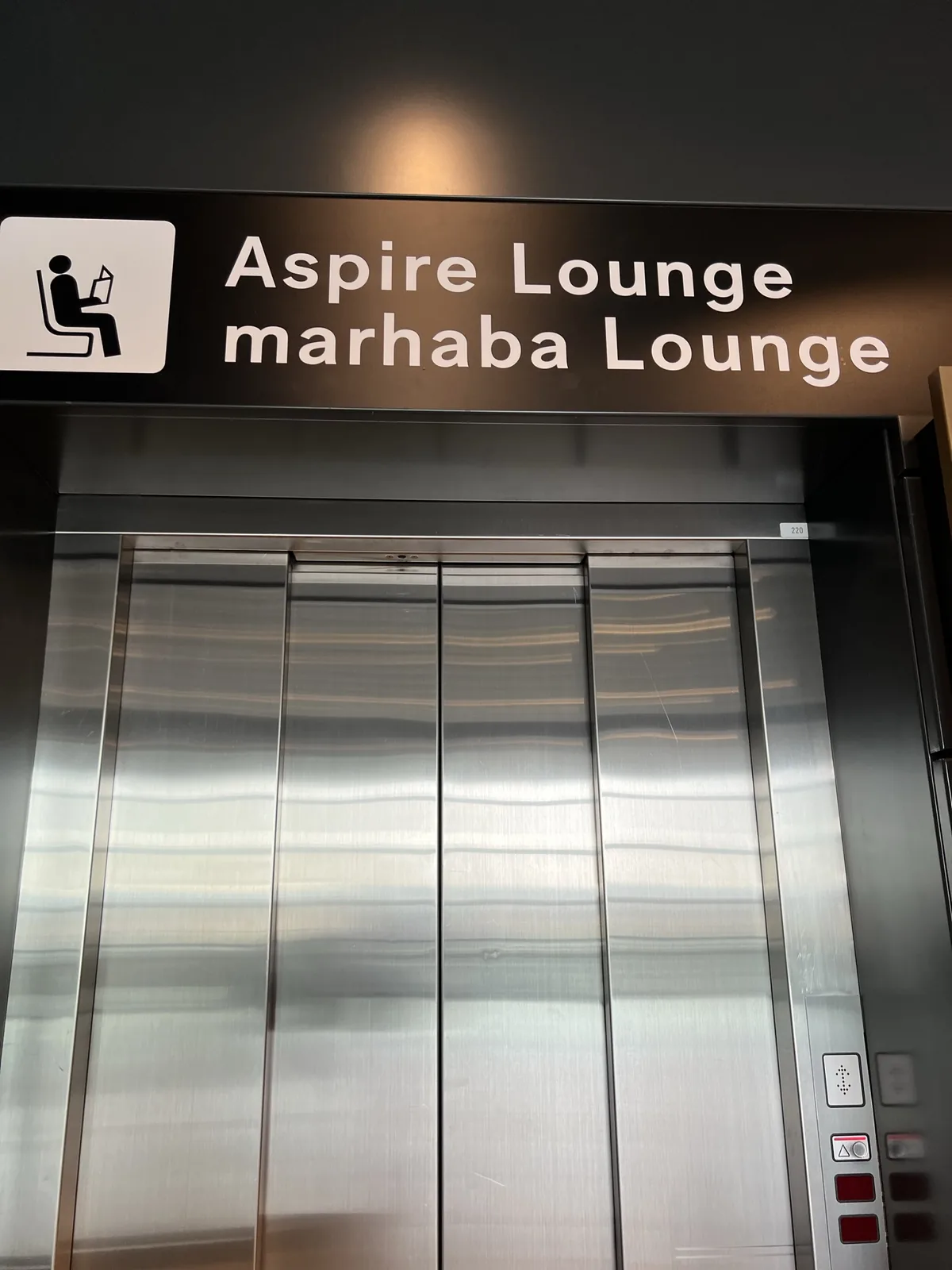 Signage for the Aspire Lounge and marhaba Lounge at an airport